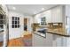 Bright kitchen features white cabinets, granite countertops, stainless appliances, and backyard access at 2947 Margaret Mitchell Nw Ct, Atlanta, GA 30327
