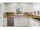 Bright kitchen features white cabinets, granite counters, stainless steel appliances, and natural light at 2947 Margaret Mitchell Nw Ct, Atlanta, GA 30327