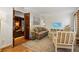 Comfortable living room with hardwood floors, neutral decor, and seamless flow to the den at 2947 Margaret Mitchell Nw Ct, Atlanta, GA 30327