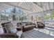 Bright screened porch with vaulted ceiling, plenty of natural light, and comfortable wicker furniture at 2947 Margaret Mitchell Nw Ct, Atlanta, GA 30327
