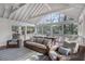 Spacious screened porch with vaulted ceiling, comfortable seating, and serene outdoor views at 2947 Margaret Mitchell Nw Ct, Atlanta, GA 30327