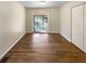 Hardwood floors and neutral walls enhance a bedroom with a sliding glass door to a screened porch at 3668 Bunker Hill Sw Dr, Atlanta, GA 30331
