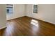 Bedroom featuring hardwood floors, neutral walls and a double window at 3668 Bunker Hill Sw Dr, Atlanta, GA 30331