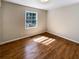 Bedroom featuring hardwood floors, neutral walls and a sunlit window at 3668 Bunker Hill Sw Dr, Atlanta, GA 30331