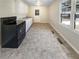 Bright kitchen with tile floors, white cabinets and modern black appliances at 3668 Bunker Hill Sw Dr, Atlanta, GA 30331