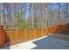 View of a backyard stone patio with privacy fence, creating a serene and secluded outdoor retreat at 5022 Towneship Creek Rd, Roswell, GA 30075