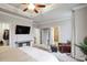 This main bedroom features tray ceilings, ceiling fan, and a sitting area to enjoy the natural light at 5022 Towneship Creek Rd, Roswell, GA 30075