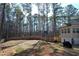 Spacious backyard with a tall wooden fence, complemented by mature trees, great for outdoor activities at 55 Bonds Ct, Hiram, GA 30141