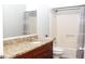 Bathroom featuring a granite countertop, a framed mirror, and a shower with gray patterned curtain at 55 Bonds Ct, Hiram, GA 30141