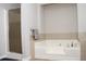 Modern bathroom featuring a walk-in shower and a corner soaking tub with tile surround at 55 Bonds Ct, Hiram, GA 30141