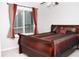 Comfortable bedroom with a large window, a ceiling fan and a luxurious sleigh bed with decorative pillows at 55 Bonds Ct, Hiram, GA 30141