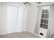 A simple bedroom featuring a folding door closet, and neutral colored walls at 55 Bonds Ct, Hiram, GA 30141