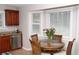 Cozy kitchen nook with a charming round table and ample natural light, complemented by cherry cabinets at 55 Bonds Ct, Hiram, GA 30141