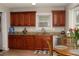 Kitchen featuring granite countertops, cherry cabinets, stainless steel appliances, and a wooden dining table at 55 Bonds Ct, Hiram, GA 30141