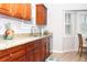 Bright kitchen showcasing granite counters, cherry cabinets, stainless steel appliances, complemented by natural light at 55 Bonds Ct, Hiram, GA 30141