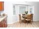 Sun-lit breakfast nook with a charming round table, complemented by bright windows and cherry cabinets at 55 Bonds Ct, Hiram, GA 30141