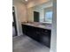 Bathroom vanity with double sinks, granite countertops, and dark cabinetry at 1001 Brading Pl, Lawrenceville, GA 30043
