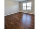 Bedroom featuring hardwood floors and a window, offering a bright and inviting space at 1001 Brading Pl, Lawrenceville, GA 30043