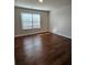 Bedroom featuring hardwood floors and a window, offering a bright and inviting space at 1001 Brading Pl, Lawrenceville, GA 30043