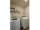 Convenient laundry room with newer washer and dryer units, and shelving at 1001 Brading Pl, Lawrenceville, GA 30043