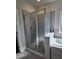 Walk-in shower featuring tile surround, glass door, and rainfall showerhead at 1001 Brading Pl, Lawrenceville, GA 30043