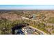 A scenic aerial view of a townhouse community with a backdrop of trees, a river, and a distant mountain range at 10035 River Rock Dr, Roswell, GA 30076