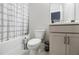Neat bathroom featuring a shower-tub combo with a stylish shower curtain, toilet, and grey vanity at 10035 River Rock Dr, Roswell, GA 30076