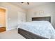 Bright bedroom with a wood-framed bed, neutral walls, and a ceiling fan, creating a cozy and inviting space at 10035 River Rock Dr, Roswell, GA 30076