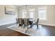 Bright dining room with modern chandelier, hardwood floors and large windows at 10035 River Rock Dr, Roswell, GA 30076