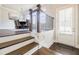 Inviting entryway with wood floors and staircase leading to the dining area at 10035 River Rock Dr, Roswell, GA 30076