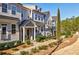 Well-maintained townhomes feature gray siding and manicured landscaping at 10035 River Rock Dr, Roswell, GA 30076