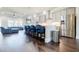 Modern kitchen with stainless steel appliances, island seating, and hardwood floors at 10035 River Rock Dr, Roswell, GA 30076