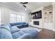 Comfortable living room with a stone fireplace, built-in shelves, and a large window at 10035 River Rock Dr, Roswell, GA 30076