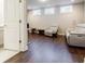 Modern room with hardwood floors showcasing media center with large screen, couch and accent seating at 10035 River Rock Dr, Roswell, GA 30076