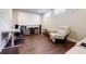 Entertainment space with hardwood floors, including a reclining chair, media console, projector screen, and desk area at 10035 River Rock Dr, Roswell, GA 30076