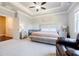 Spacious primary bedroom with large bed, bedside tables, and a walk in closet at 10035 River Rock Dr, Roswell, GA 30076