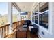 Relaxing covered patio area with comfortable seating, an outdoor grill, and views of the surrounding landscape at 10035 River Rock Dr, Roswell, GA 30076