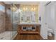 Bathroom featuring a double vanity, walk-in shower, and floral wallpaper at 1784 Terry Mill Se Rd, Atlanta, GA 30316