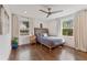 Bright bedroom with large windows, hardwood floors, and a ceiling fan at 1784 Terry Mill Se Rd, Atlanta, GA 30316