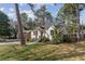 Quaint white home featuring a striking red door, complemented by the lush greenery of the surrounding landscape at 1784 Terry Mill Se Rd, Atlanta, GA 30316