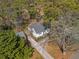 Aerial view of charming white home with driveway, trees, and mature landscaping at 1784 Terry Mill Se Rd, Atlanta, GA 30316