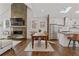 Open-concept living space showcasing hardwood floors, a modern fireplace, and a seamless transition to the kitchen at 1784 Terry Mill Se Rd, Atlanta, GA 30316