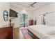 Main bedroom featuring a tray ceiling, access to a private balcony, and a barn door entrance to the bathroom at 1784 Terry Mill Se Rd, Atlanta, GA 30316