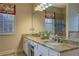 Bathroom featuring granite countertops, dual sinks, and decorative window treatments at 480 Firelite Ln, Suwanee, GA 30024