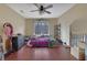 Spacious bedroom featuring hardwood floors, large window and ceiling fan at 480 Firelite Ln, Suwanee, GA 30024