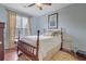 Cozy bedroom with blue walls, hardwood floors, and large window at 480 Firelite Ln, Suwanee, GA 30024