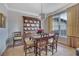Traditional dining room featuring a wooden table set, chandelier, and bright natural light at 480 Firelite Ln, Suwanee, GA 30024