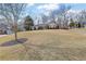 Ranch home with manicured front yard and mature trees on a sunny lot in a residential neighborhood at 480 Firelite Ln, Suwanee, GA 30024