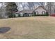Ranch home with manicured front yard and mature trees on a sunny lot in a residential neighborhood at 480 Firelite Ln, Suwanee, GA 30024