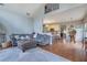 Open-concept living space featuring hardwood floors, a comfortable couch, and seamless kitchen access at 480 Firelite Ln, Suwanee, GA 30024